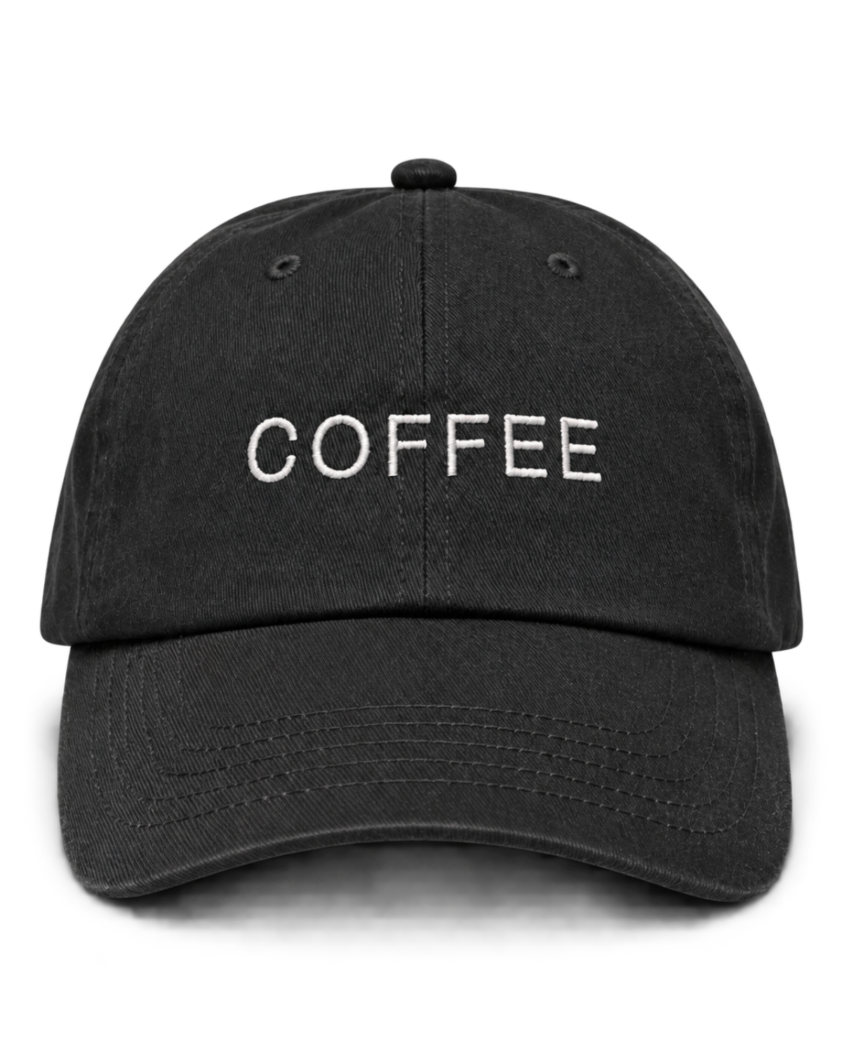 The front of a black baseball cap featuring 'COFFEE' embroidered in cream above the brim.