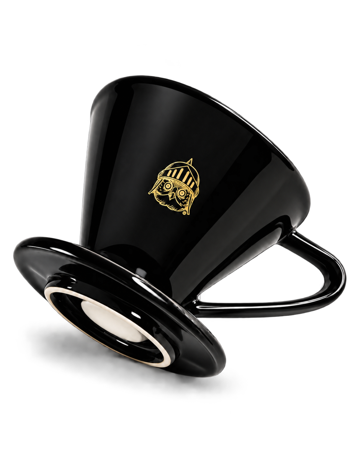 A glossy black ceramic coffee dripper with a matching saucer, featuring a small gold owl logo on the side, set against a plain white background.