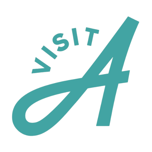 A teal graphic logo featuring the word 'VISIT' in arched uppercase letters above a large stylized letter 'A' on a plain white background. Visit Anaheim Logo.
