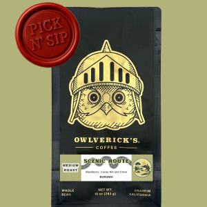 Front of Black Coffee Bag with Owl Design named Scenic Route. Red stamp says "Pick N' Sip" to designate that this is for a pickup only product. Pickup is August 14, 2026 between 9am and 12pm.
